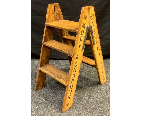 Interior design - A retro pine step ladder, printed to sides ‘Moët &amp; Chandon’, ‘Bollinger’, 81cm high. 