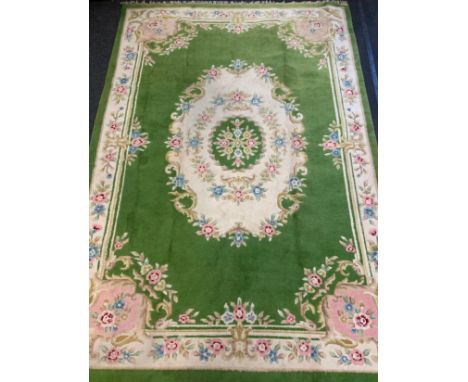 An Indian hand-made carpet / rug, in green, blue, and cream, 412cm x 280cm. 