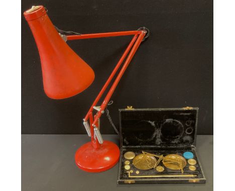 A Herbert Terry angle poise lamp, red/orange, cast marks, weighted base;  set of scales (2) 