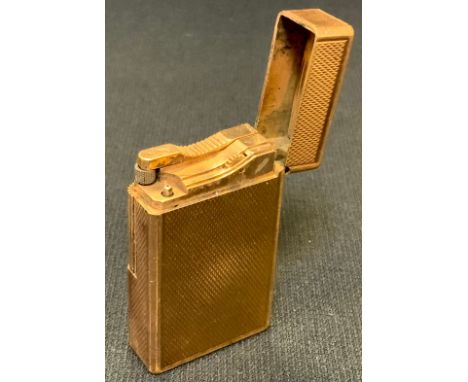 A vintage DuPont gold coloured pocket lighter, engine turned finish, made in France, serial no 4826BB 