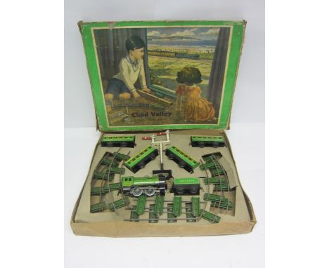 A boxed Chad Valley 0 gauge Clockwork Southern Passenger Set, comprising tinplate 0-4-0 locomotive no.3402, tender, four coac