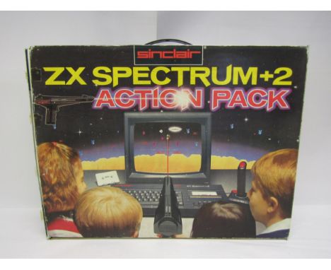 A boxed Sinclair ZX Spectrum +2 Action Pack vintage computer gaming console including light gun, joystick and power supply, t