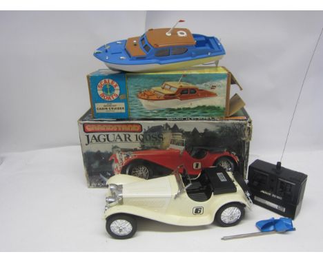 A Grandstand Jaguar 100SS 1:10 scale radio control car and a Scalex Boats 414S Derwent Cabin Cruiser (2, boxes worn) 