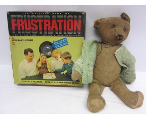 A careworn mid 20th Century straw filled teddy bear with glass eyes and a vintage Frustration board game (2) 