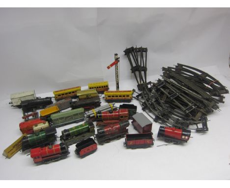 A collection of assorted playworn 0 gauge model railway locomotives, rolling stock and accessories including Chad Valley, Hor