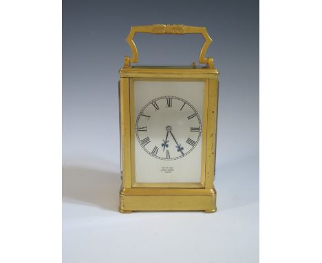 AN ENGLISH GILT BRASS REPEATING CARRIAGE CLOCK BY JAMES MCCABE, NO. 2660 The acanthus loop handle over a bevelled glass panel