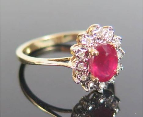 A Ruby and Diamond Ring in 9ct yellow gold setting, size N.5