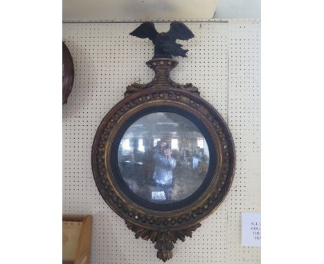 An Early Nineteenth Century Gilt Wood Convex Mirror with eagle pediment, 95cm high