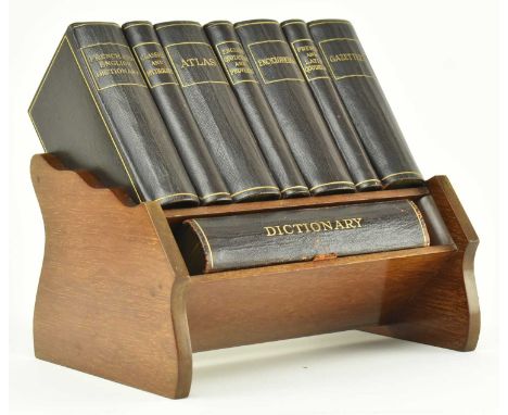 An Asprey &amp; Co. Ltd Miniature Reference Library, presented on original carved oak shelf desk stand. Titles comprising Fre