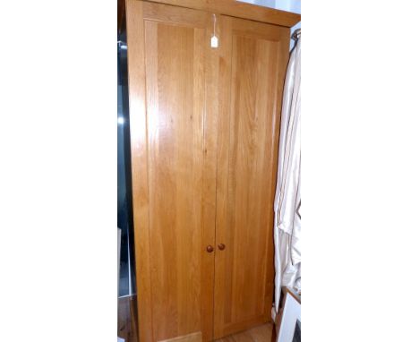 Contemporary oak free standing larder, the twin panel doors opening to reveal fitted shelves to the reverse and interior with