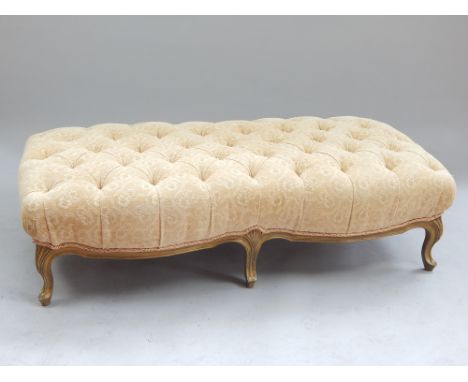 Louis XV style gilt and upholstered foot stool, the button upholstered seat on six moulded cabriole legs, 155cm w