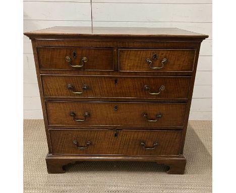 An oak chest of drawers on bracket feet (H84cm W84cm D50cm)