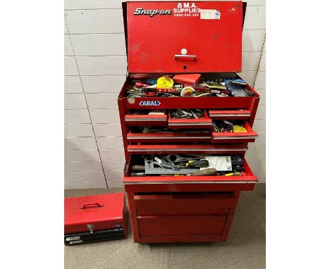 A Snap on Tool box with content, axe and one empty tool box 