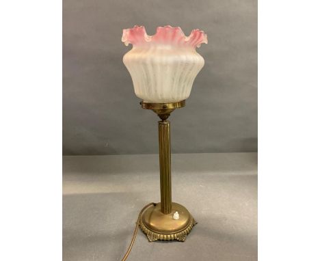 A brass column lamp with glass shade