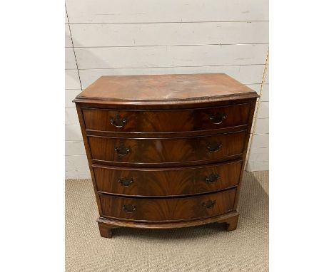 A bow fronted chest of drawers with graduated draws on bracket feet (H84cm W80cm D53cm)