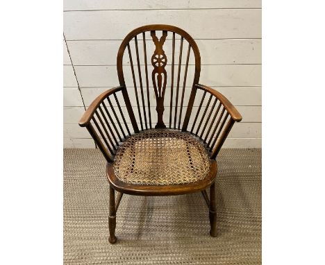 A wheel back stick chair with can seat 