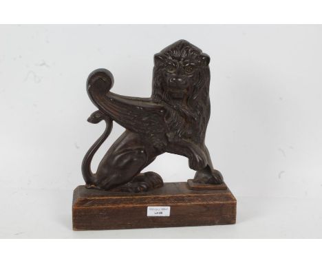 Cast iron door stop,in the form of a griffin, with wooden base, 26cm wide