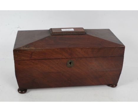 Victorian mahogany tea caddy, of sarcophagus form, the hinged lid enclosing a three section interior, raised on bun feet, 30.