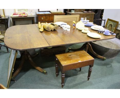 George III twin pillar oak extending dining table, the D shaped ends raised on turned columns and quadruple reeded legs termi