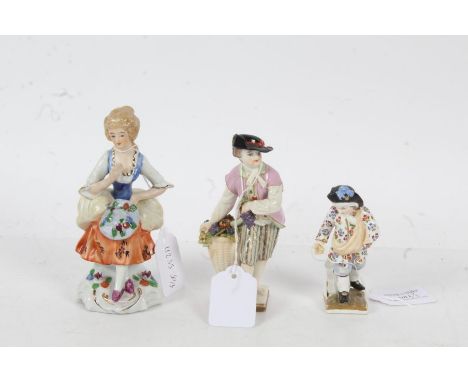 Three porcelain figures, baring marks for Dresden, Sitzendorf etc, one depicting a boy with a basket of fruit, the largest 14