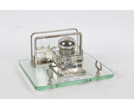 Art Deco style chrome and clear glass desk stand, the letter rack depicting horses jumping, with square inkwell, 21.5cm wide
