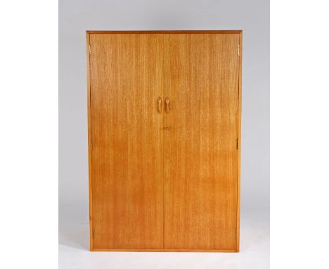 Teak two door wardrobe, the pair of doors enclosing shelves and a hanging rail, 131cm high, 89cm wide, 40.5cm deep