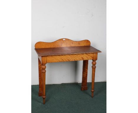 Victorian satinwood console table/side table, the rectangular top with a wavy gallery raised on turned tapering front legs, 9