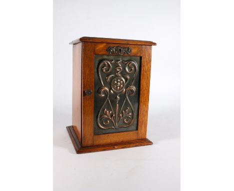 Antique oak smokers' cabinet, the door inset with an Art Nouveau copper panel, 28cm tall. 