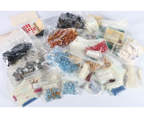 Group of uncut semi-precious gem stone to include tiger's eye, synthetic ruby red stones, etc. 