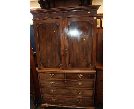 Victorian mahogany linen press, the two panelled door top above chest of two short over three long drawers, raised on bracket