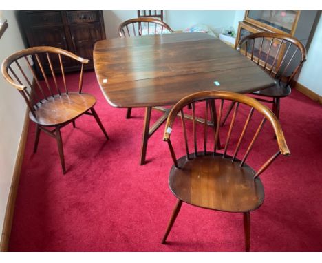 An ERCOL dining table complete with ERCOL tag dimensions 135cm x 112cm and four ERCOL style round backed chairsApprox 5 piece