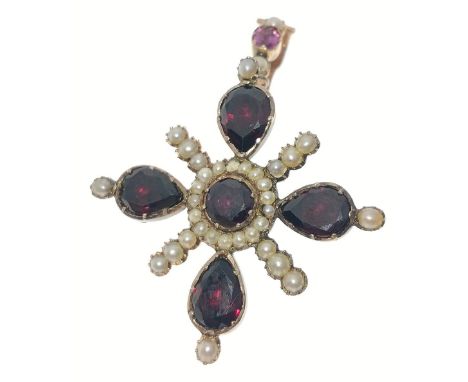 A VICTORIAN 'yellow metal' PENDANT in star shape form, with 4 large garnets 1cm in length, and with a 5th garnet centred and 