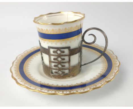 An AYNSLEY gilded COFFEE CAN and saucer with a silver WALKER &amp; HALL, Sheffield hallmarked 1925 cup holder, this is for a 