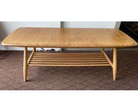 An ERCOL coffee table in light wood with magazine shelf, with ERCOL label verso,  dimensions length 104cm x 45cm width x 35cm