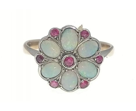 A 9ct gold opal ring with 6 opals and 7 red stones in a flower-head pattern, size M/N gross weight 2g