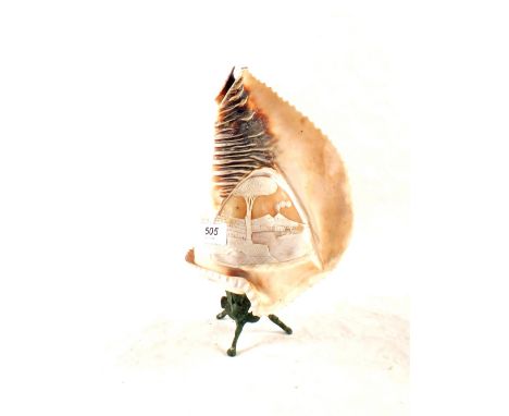 A carved cameo shell lamp