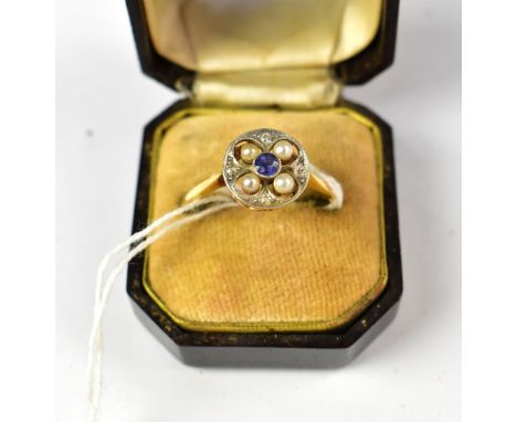 An Art Deco 18ct gold ring, the circular top with central bezel set sapphire, with four seed pearls within beaded rings, sepa