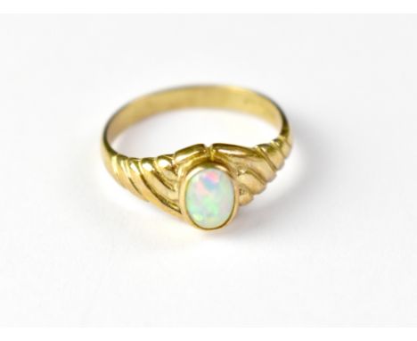 A 9ct gold opal ring, the raised bezel set opal with greens, blues and red, in a wrythen mount, size Q, approx 2.6g.