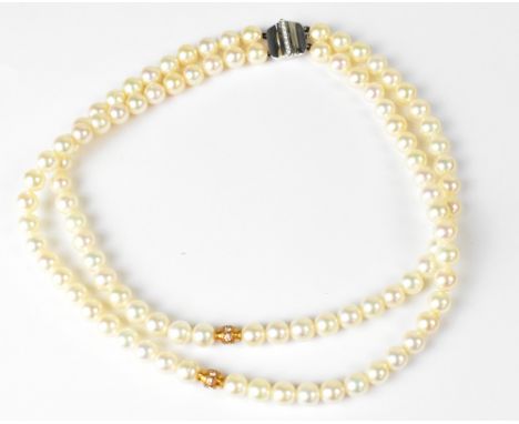 BOODLE &amp; DUNTHORNE; a double-strand well matched pearl necklace, the centre of each strand with rose-coloured links set w