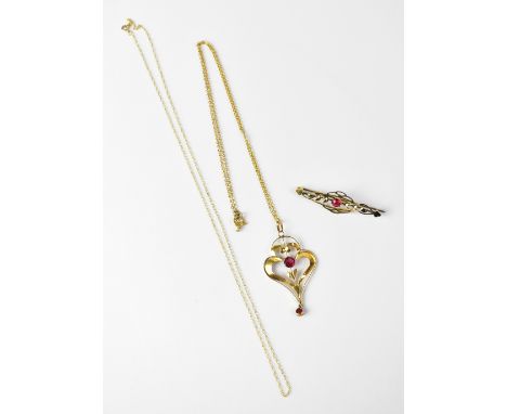A 9ct gold Art Nouveau pendant set with garnet, with single garnet suspended beneath, stamped '9CT', on a fine chain link nec