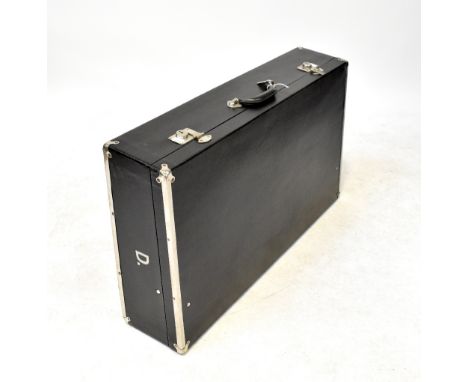 A refurbished vintage black leatherette and metal bound car trunk, with white linen cushioned interior, inscribed to both sid