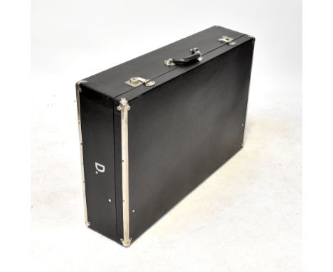 A refurbished vintage black leatherette and metal bound car trunk, with white linen cushioned interior, inscribed to both sid