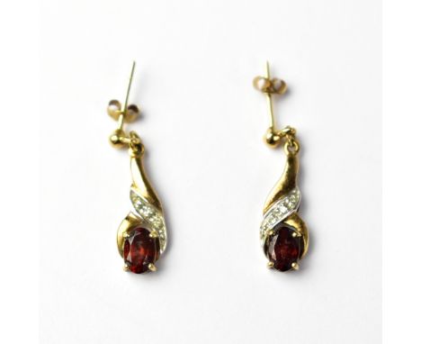 A a pair of yellow metal earrings set with diamonds and garnets, unmarked, together with a matching 9ct gold ring set with ga