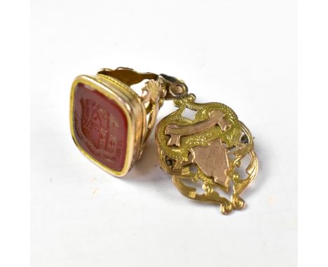 A Victorian yellow metal seal with intaglio armorial crest and banner, in a typical Victorian mount, together with a 9ct gold