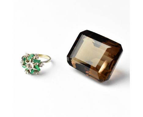 A large smoky quartz emerald cut stone, together with a costume ring floral set with white and green stones, size Q1/2 (2). C