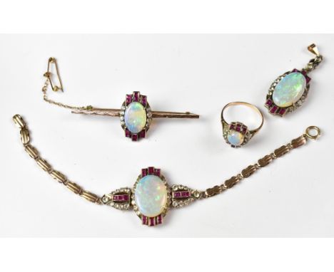 An Art Deco parure of yellow metal jewellery, all with matching designs of a central oval white opals, with three rows of two