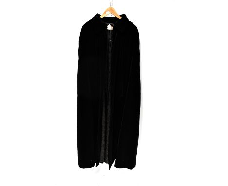 A black crushed velvet full-length cloak by Quad, with a toggle and rope clasp, length approx 140cm.