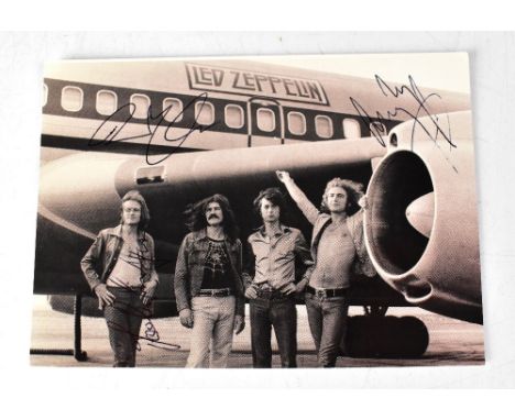 LED ZEPPELIN; a black and white postcard bearing signatures, and two others (3).We have not authenticated these signatures, p