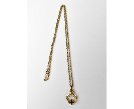 A 9ct gold pendant set with a single garnet in a ropetwist setting, on a 9ct gold ropetwist chain necklace, stamped '375', ap