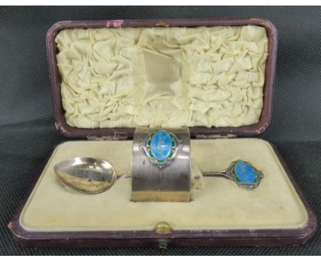 An early 20th century hallmarked silver baby napkin ring and spoon set, the napkin ring with a blue enamelled cartouche inscr